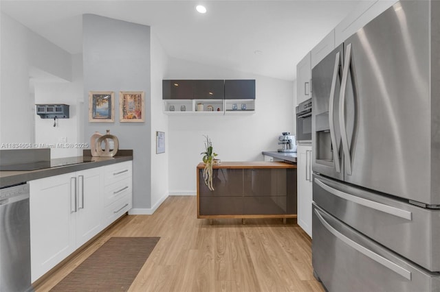 16410 Sapphire Bnd, Weston, FL 33331 - kitchen featuring appliances with stainless steel finishes, light wood-type flooring, vaulted ceiling, white cabinets, and dark countertops