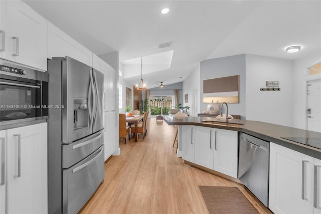 16410 Sapphire Bnd, Weston, FL 33331 - kitchen featuring stainless steel appliances, dark countertops, white cabinetry, light wood-style floors, and recessed lighting