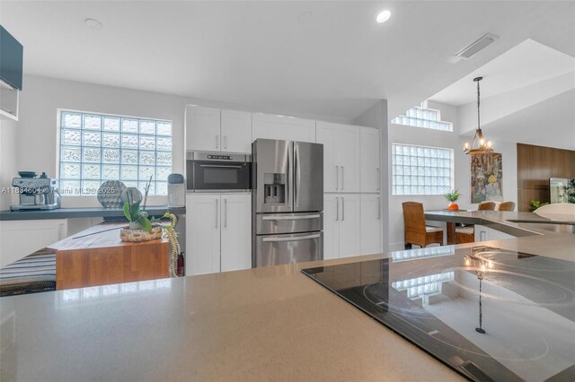 16410 Sapphire Bnd, Weston, FL 33331 - kitchen featuring appliances with stainless steel finishes, a chandelier, pendant lighting, white cabinets, and recessed lighting