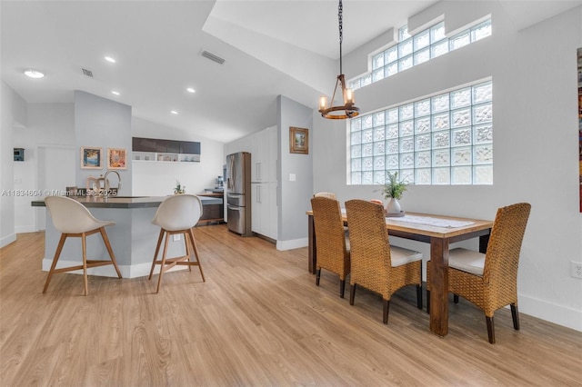 16410 Sapphire Bnd, Weston, FL 33331 - dining space with light wood-style flooring, a chandelier, recessed lighting, and high vaulted ceiling