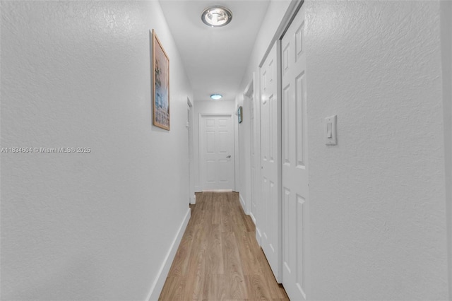 16410 Sapphire Bnd, Weston, FL 33331 - hall featuring a textured wall and light wood finished floors