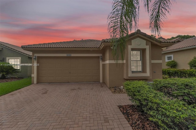 16410 Sapphire Bnd, Weston, FL 33331 - view of front of house featuring stucco siding, decorative driveway, and an attached garage