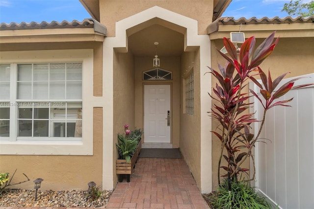 16410 Sapphire Bnd, Weston, FL 33331 - view of exterior entry featuring stucco siding and a tiled roof