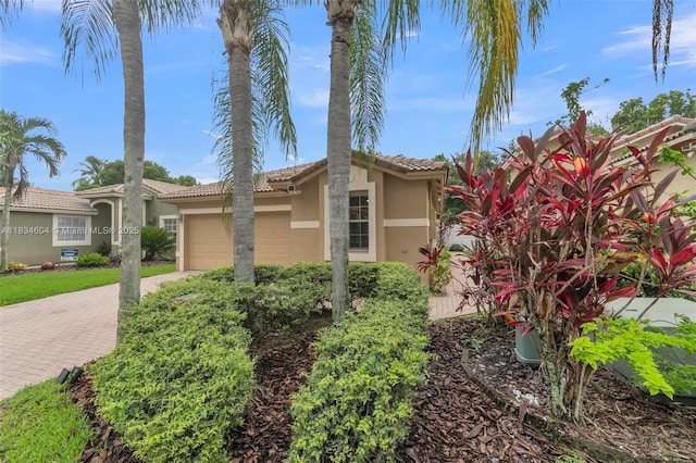 16410 Sapphire Bnd, Weston, FL 33331 - view of property exterior with stucco siding, a garage, decorative driveway, and a tile roof