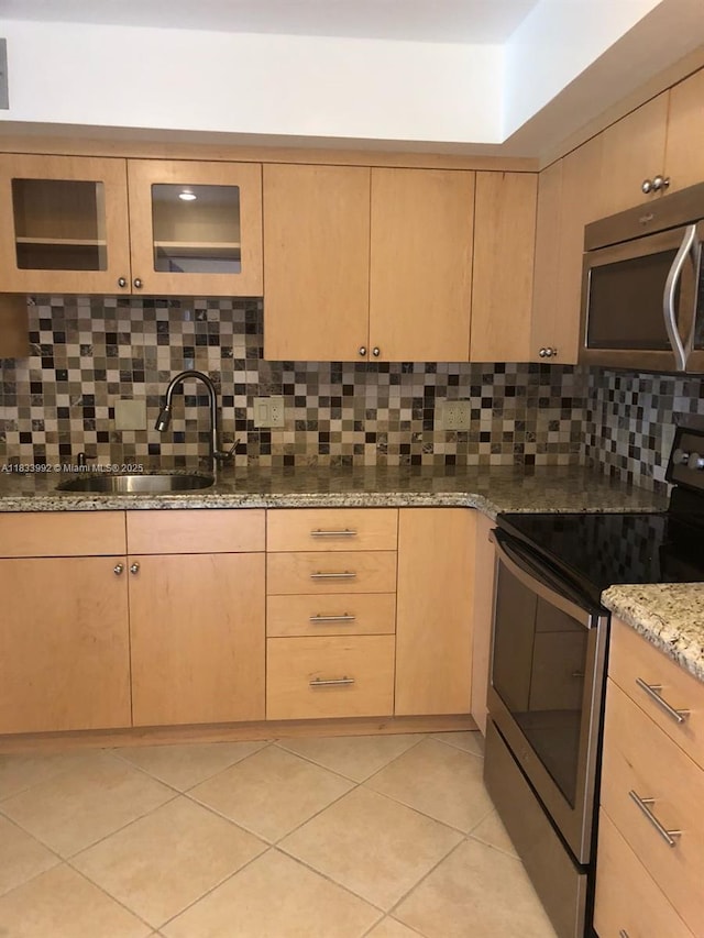 4000 N Hills Dr Unit 32, Hollywood, FL 33021 - kitchen featuring stainless steel appliances, light brown cabinetry, light stone countertops, backsplash, and light tile patterned floors