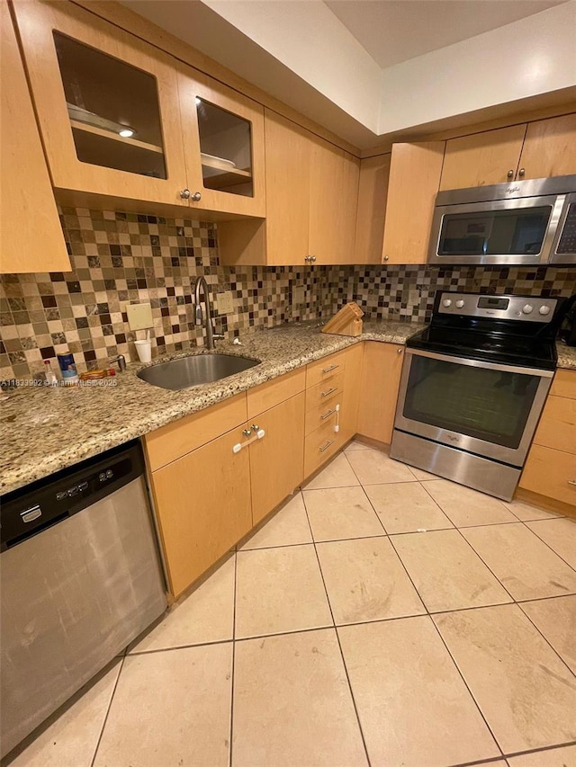 4000 N Hills Dr Unit 32, Hollywood, FL 33021 - kitchen featuring stainless steel appliances, backsplash, light brown cabinets, light tile patterned floors, and light stone counters