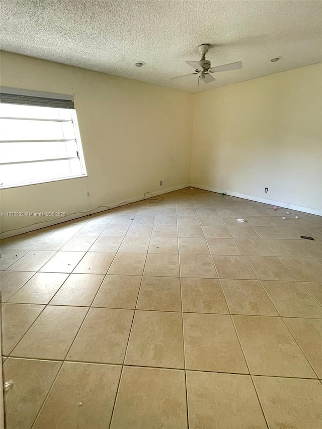 4000 N Hills Dr Unit 32, Hollywood, FL 33021 - tiled empty room with a textured ceiling and a ceiling fan