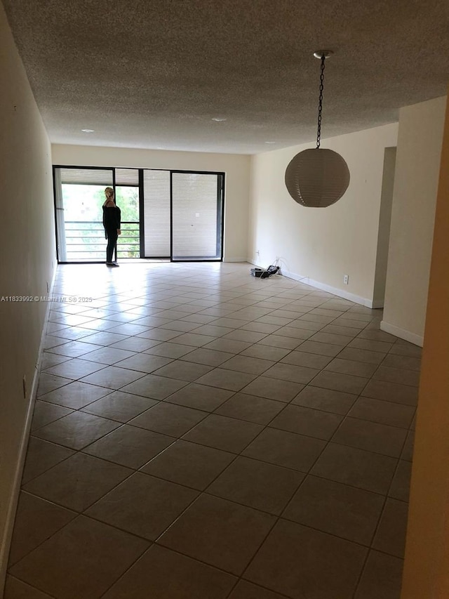 4000 N Hills Dr Unit 32, Hollywood, FL 33021 - tiled empty room featuring a textured ceiling and baseboards