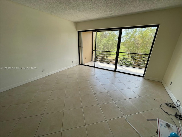 4000 N Hills Dr Unit 32, Hollywood, FL 33021 - tiled empty room with a textured ceiling and baseboards