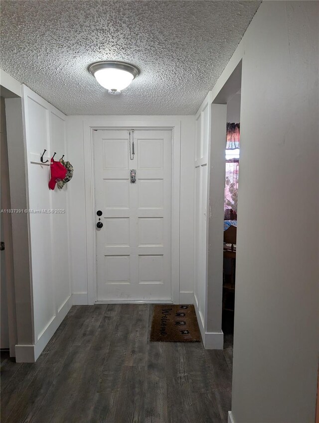 6751 Cypress Rd Unit 405, Plantation, FL 33317 - doorway to outside with dark wood-type flooring and a textured ceiling