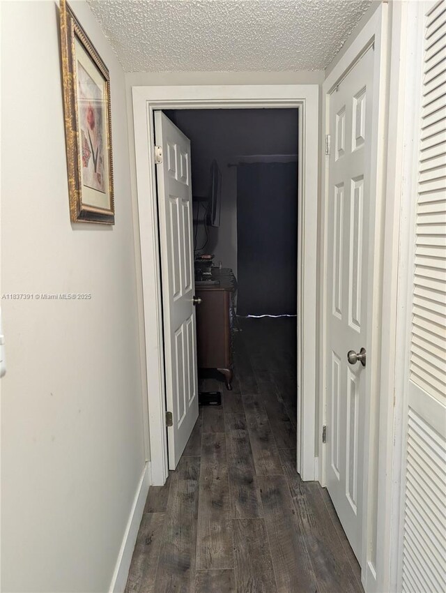 6751 Cypress Rd Unit 405, Plantation, FL 33317 - corridor with dark wood finished floors and a textured ceiling