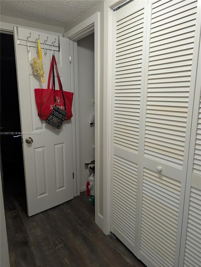 6751 Cypress Rd Unit 405, Plantation, FL 33317 - hallway with dark wood finished floors and a textured ceiling