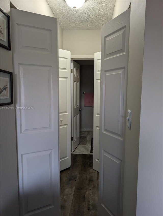 6751 Cypress Rd Unit 405, Plantation, FL 33317 - hallway featuring dark wood-style flooring and a textured ceiling