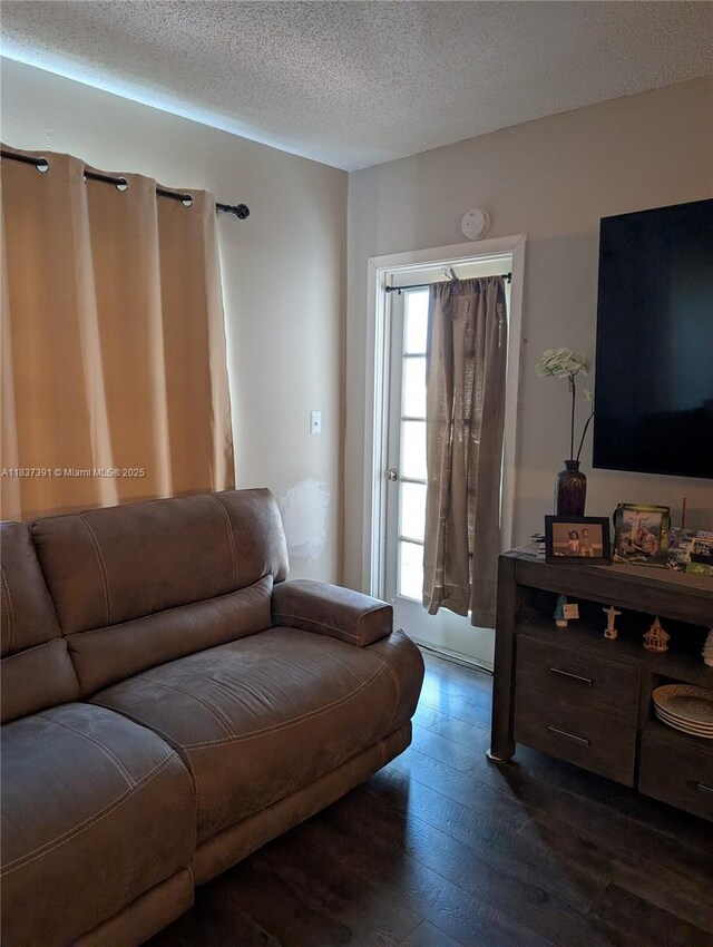 6751 Cypress Rd Unit 405, Plantation, FL 33317 - living room featuring dark wood finished floors and a textured ceiling