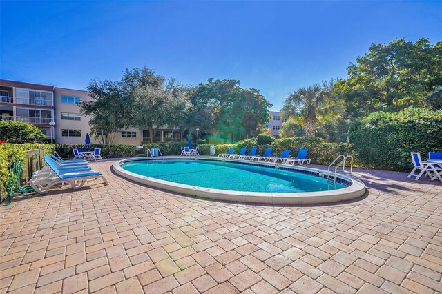 6751 Cypress Rd Unit 405, Plantation, FL 33317 - community pool with a patio area