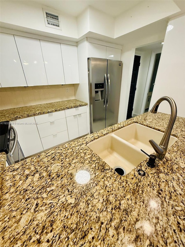 3800 N Hills Dr Unit 312, Hollywood, FL 33021 - kitchen featuring stainless steel fridge with ice dispenser, modern cabinets, white cabinetry, and light stone counters