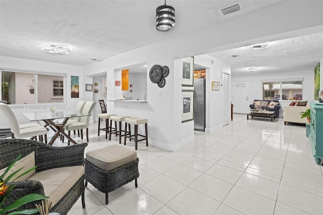 4803 NW 47th Ter, Tamarac, FL 33319 - living room with a textured ceiling and light tile patterned floors