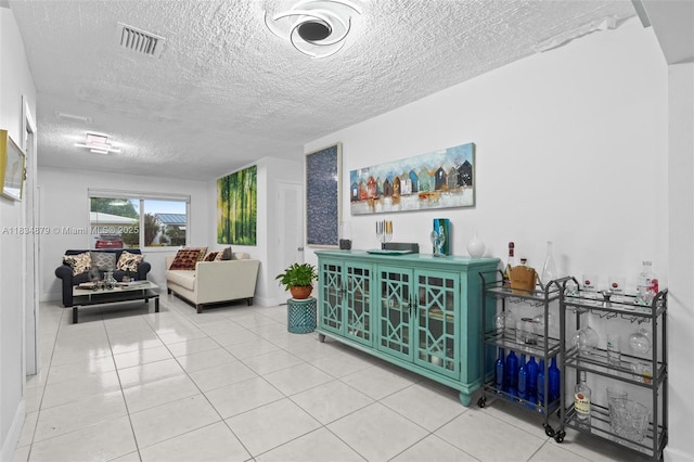 4803 NW 47th Ter, Tamarac, FL 33319 - living room with a textured ceiling and light tile patterned floors