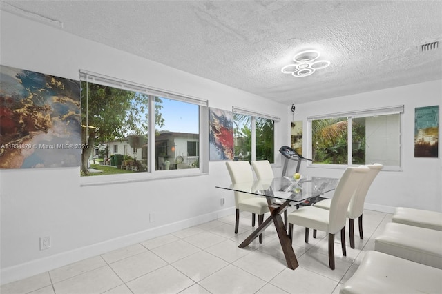 4803 NW 47th Ter, Tamarac, FL 33319 - dining area featuring a textured ceiling, plenty of natural light, and tile patterned flooring