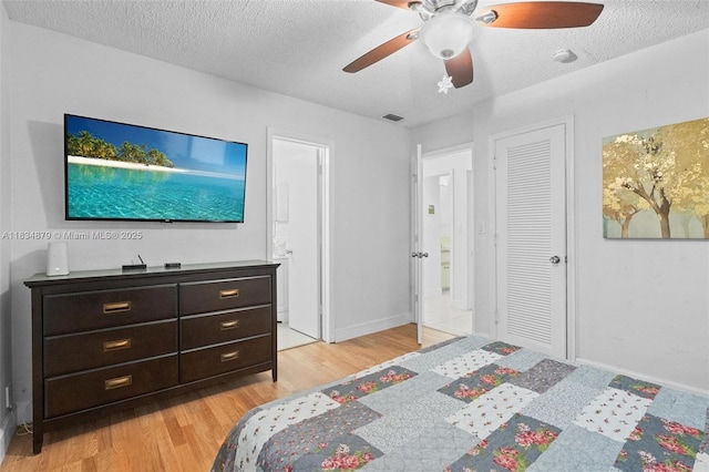 4803 NW 47th Ter, Tamarac, FL 33319 - bedroom featuring light wood-style floors, a textured ceiling, ceiling fan, and a closet