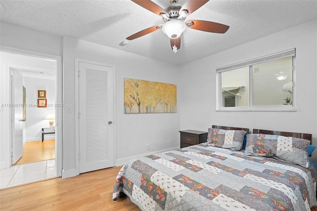 4803 NW 47th Ter, Tamarac, FL 33319 - bedroom with wood finished floors, a textured ceiling, and a ceiling fan