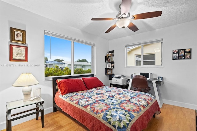 4803 NW 47th Ter, Tamarac, FL 33319 - bedroom with a textured ceiling, wood finished floors, and ceiling fan
