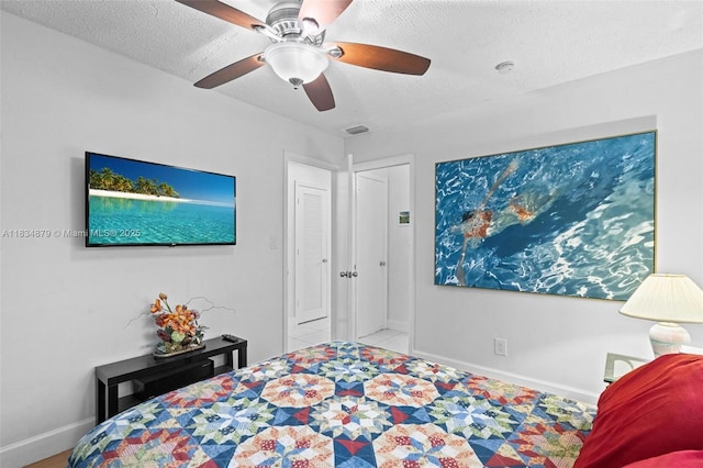 4803 NW 47th Ter, Tamarac, FL 33319 - bedroom with a textured ceiling and a ceiling fan