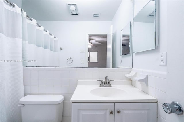 4803 NW 47th Ter, Tamarac, FL 33319 - bathroom featuring tile walls, vanity, and a ceiling fan
