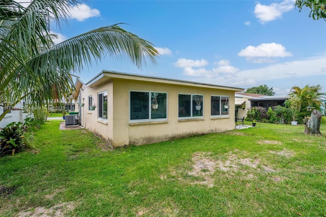 4803 NW 47th Ter, Tamarac, FL 33319 - rear view of house featuring stucco siding and a lawn
