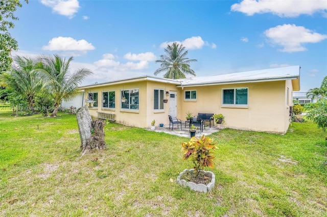 4803 NW 47th Ter, Tamarac, FL 33319 - back of property with stucco siding, a patio, and a yard