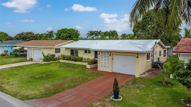 4803 NW 47th Ter, Tamarac, FL 33319 - ranch-style house with an attached garage, concrete driveway, stucco siding, and a front yard