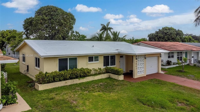 4803 NW 47th Ter, Tamarac, FL 33319 - ranch-style house with an attached garage, concrete driveway, a front yard, and stucco siding