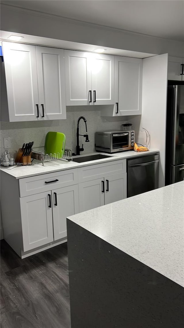 9850 Hammocks Blvd Unit 107, Miami, FL 33196 - kitchen with dishwashing machine, freestanding refrigerator, dark wood finished floors, and white cabinets
