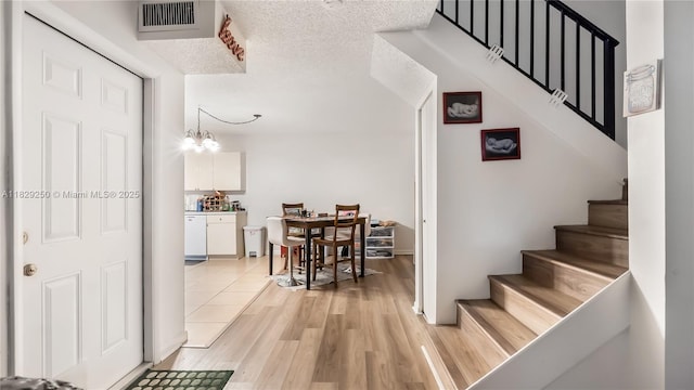 9111 SW 22nd Ct Unit B-3, Davie, FL 33324 - stairway featuring wood finished floors and a chandelier