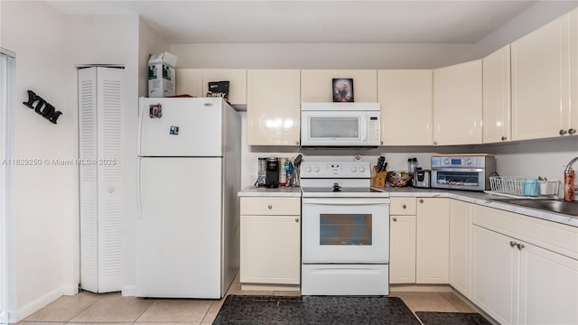 9111 SW 22nd Ct Unit B-3, Davie, FL 33324 - kitchen with white appliances, light tile patterned floors, and white cabinetry