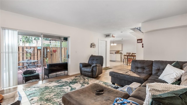9111 SW 22nd Ct Unit B-3, Davie, FL 33324 - living room featuring wood finished floors and a chandelier