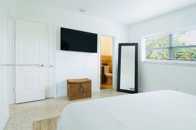 1236 NE 109th St, Miami, FL 33161 - bedroom featuring speckle patterned floor and ensuite bath