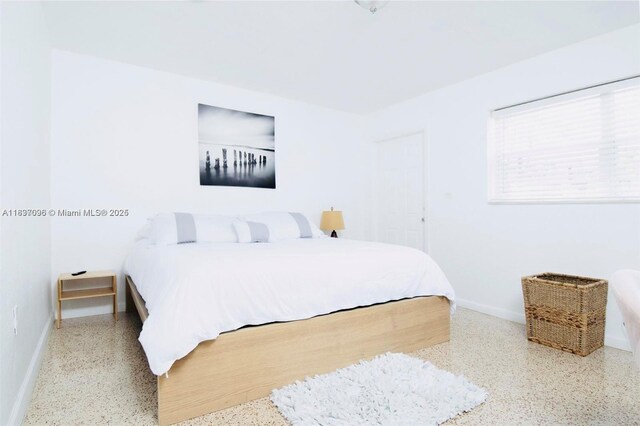 1236 NE 109th St, Miami, FL 33161 - bedroom with speckle patterned floor and baseboards