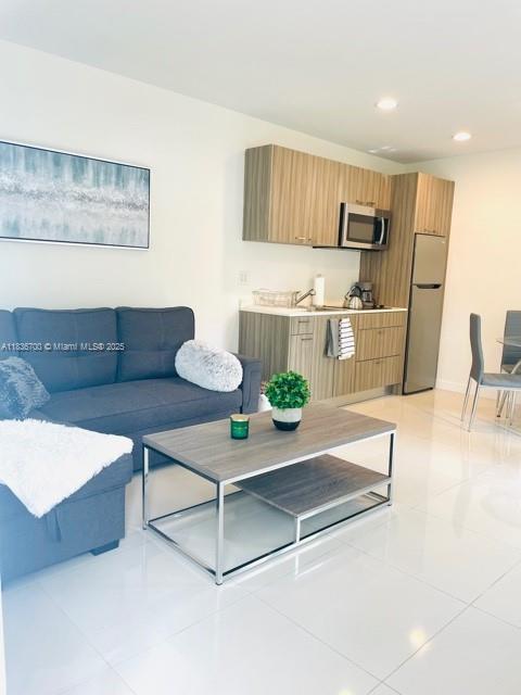 1419 W Ave Unit 106, Miami Beach, FL 33139 - living room featuring light tile patterned floors and recessed lighting