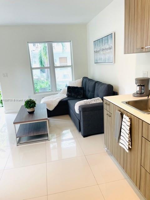 1419 W Ave Unit 106, Miami Beach, FL 33139 - living area with light tile patterned flooring