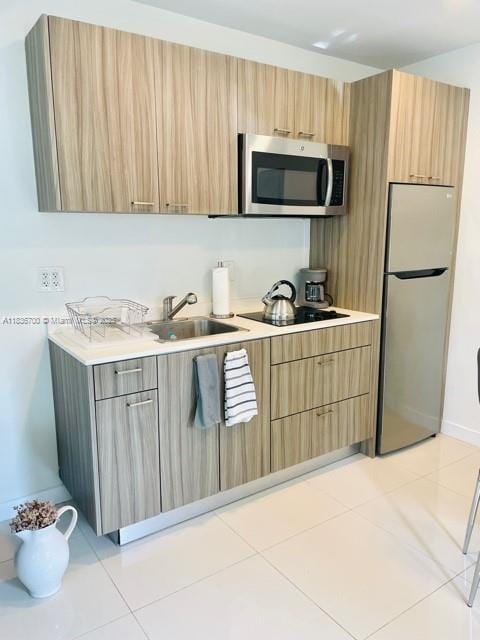 1419 W Ave Unit 106, Miami Beach, FL 33139 - kitchen featuring appliances with stainless steel finishes, modern cabinets, and light countertops