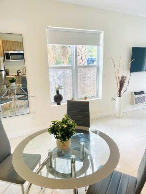 1419 W Ave Unit 106, Miami Beach, FL 33139 - tiled dining space featuring a wall unit AC and baseboards