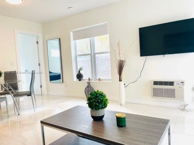 1419 W Ave Unit 106, Miami Beach, FL 33139 - living area featuring tile patterned flooring and a wall mounted air conditioner