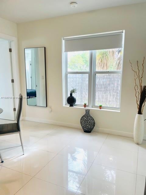 1419 W Ave Unit 106, Miami Beach, FL 33139 - tiled spare room with plenty of natural light and a smoke detector