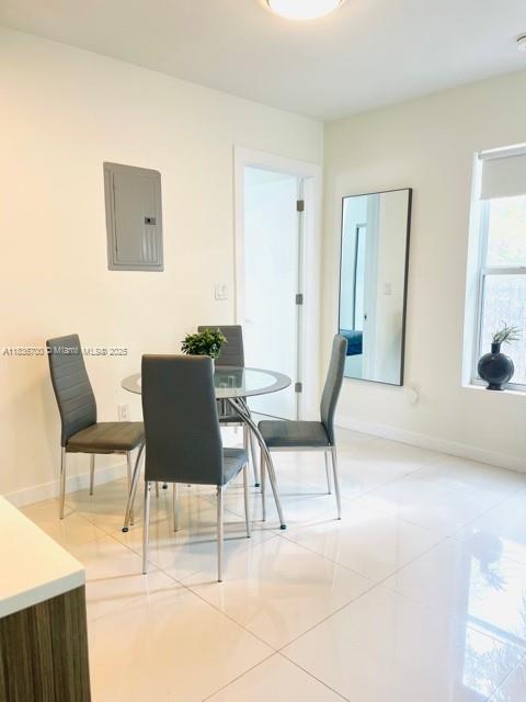 1419 W Ave Unit 106, Miami Beach, FL 33139 - dining room with electric panel and light tile patterned floors