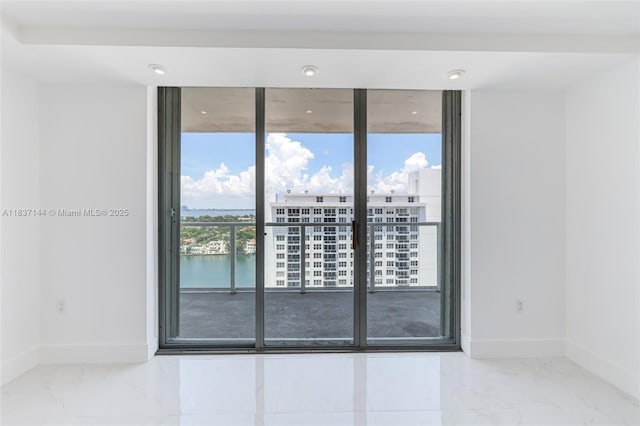 5701 Collins Ave Unit 1611, Miami Beach, FL 33140 - unfurnished room featuring a water view, expansive windows, marble finish floors, and recessed lighting