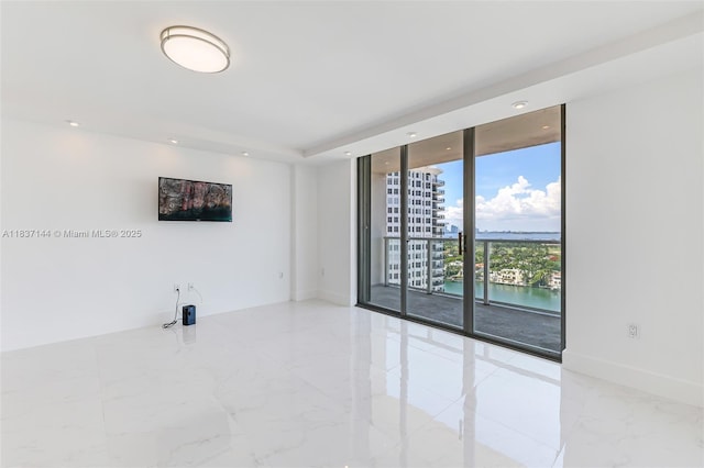 5701 Collins Ave Unit 1611, Miami Beach, FL 33140 - spare room with marble tiled floors, expansive windows, and recessed lighting