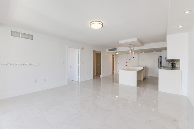 5701 Collins Ave Unit 1611, Miami Beach, FL 33140 - unfurnished living room with light marble finish floors and recessed lighting