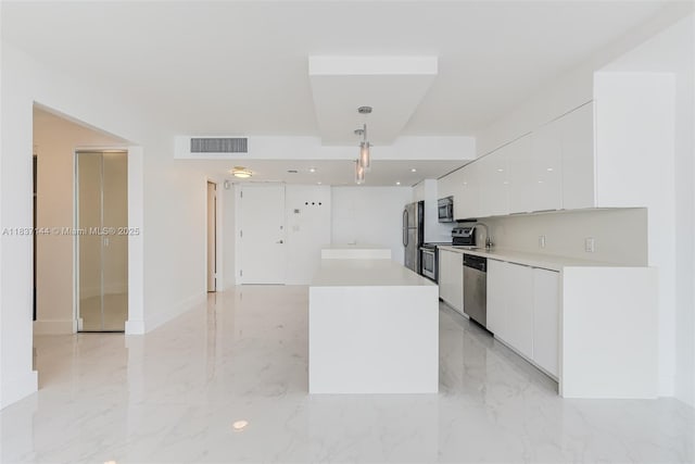 5701 Collins Ave Unit 1611, Miami Beach, FL 33140 - kitchen featuring modern cabinets, stainless steel appliances, white cabinets, hanging light fixtures, and light countertops