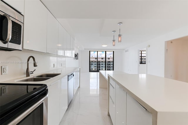 5701 Collins Ave Unit 1611, Miami Beach, FL 33140 - kitchen featuring appliances with stainless steel finishes, modern cabinets, and light marble finish flooring